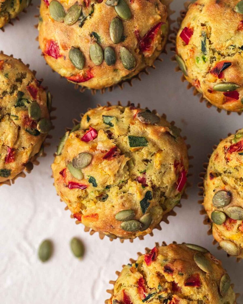 Overhead image of muffin tops showing the different vegetables and golden muffin.