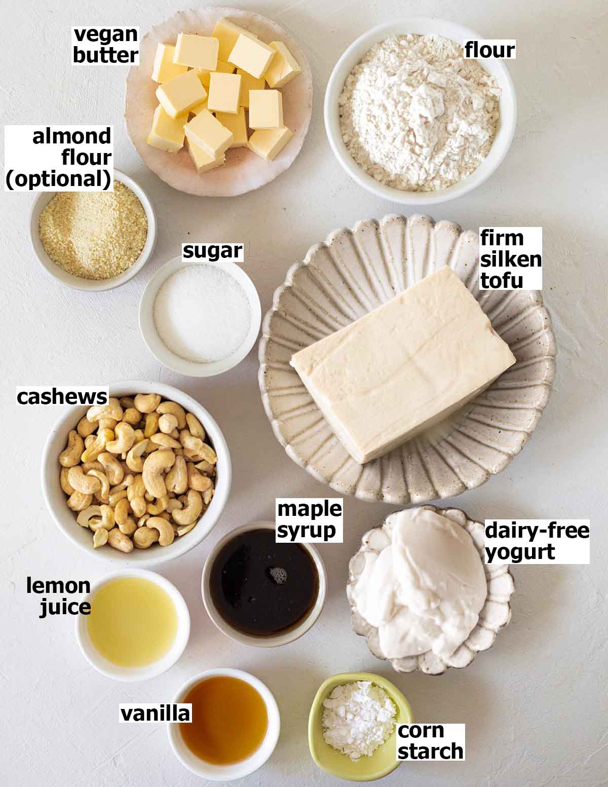 Flat-lay of ingredients for baked vegan cheesecake.