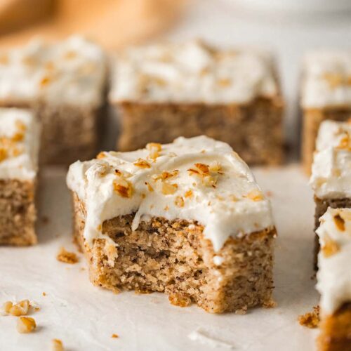 Close up of a slice of vegan banana cake with bite taken out showing fluffy texture.