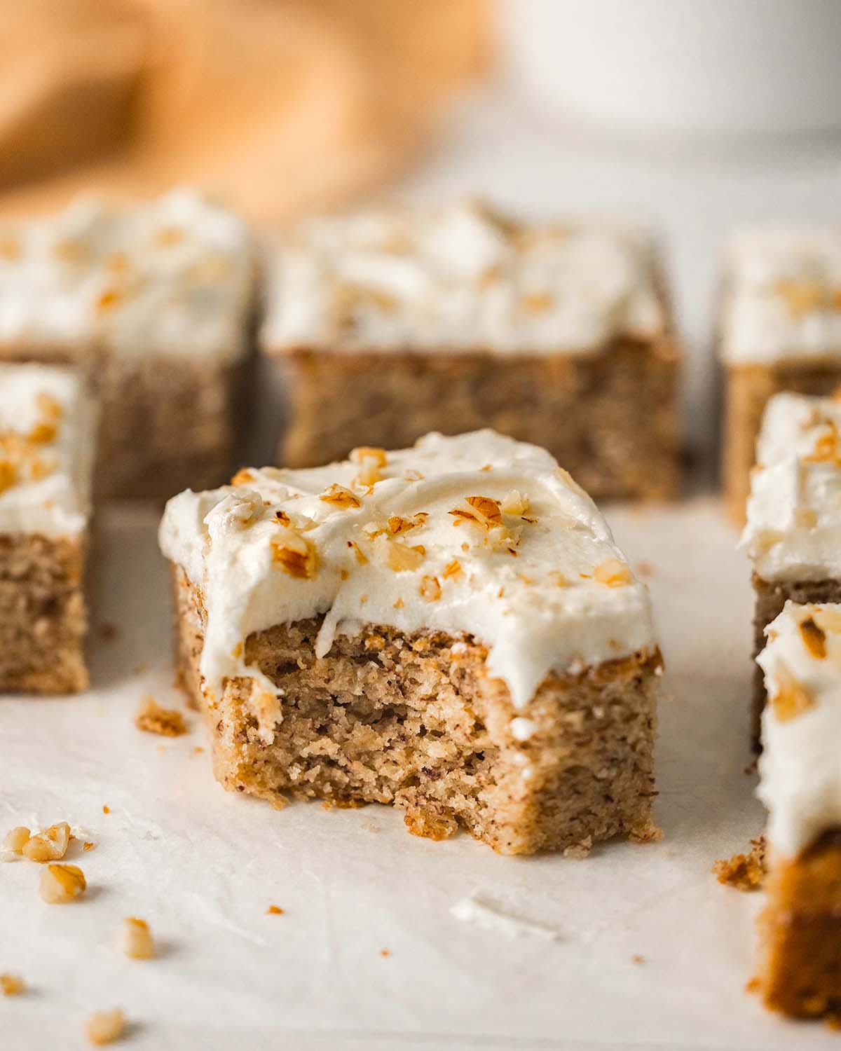 Close up of a slice of vegan banana cake with bite taken out showing fluffy texture.