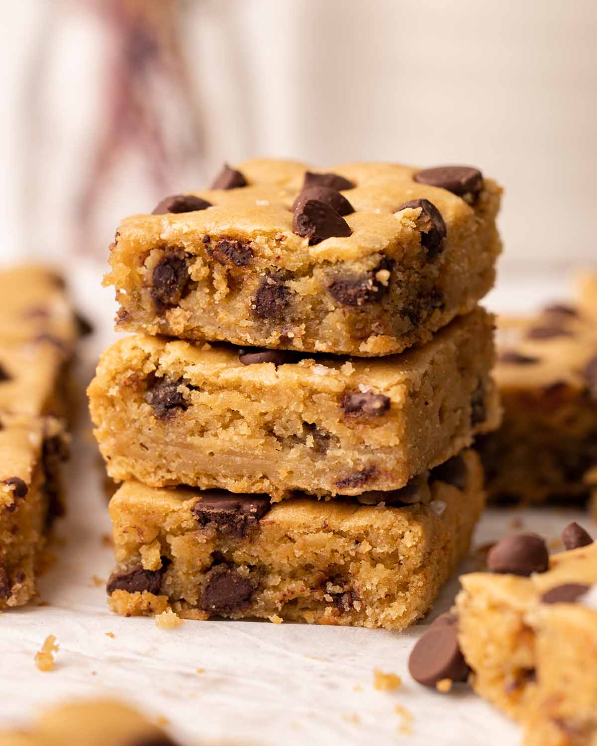 Stack of three blondies showing golden and fudgy texture.
