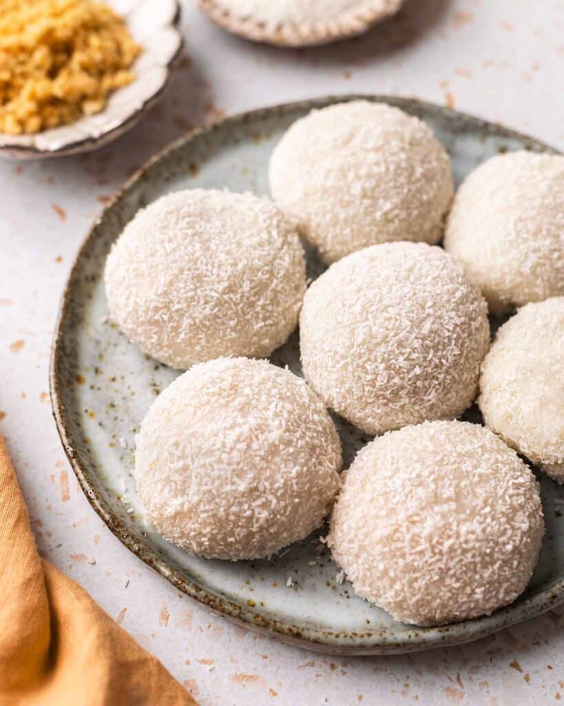 Plate with evenly-sized small round mochi balls coated with coconut.