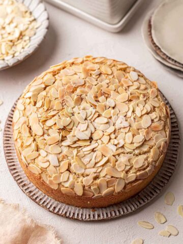 Simple one-layer cake with lots of toasted sliced almonds on top.
