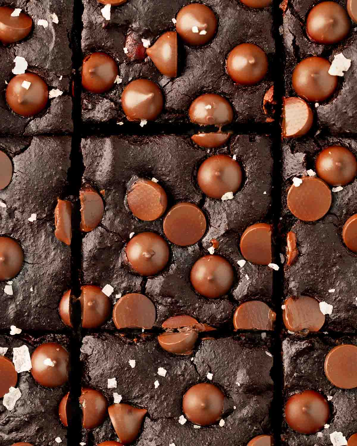 Close-up overhead image of brownies cut into bars with sprinkle of sea salt.