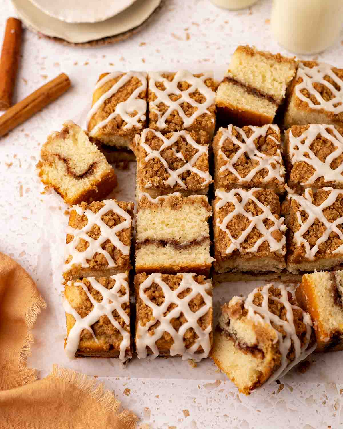 Cut up coffee cake squares with some squares on their side revealing the different layers.