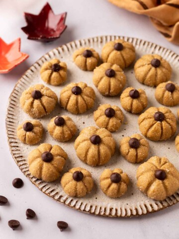 Small and cute biscoff pumpkin cake toppers on plate.