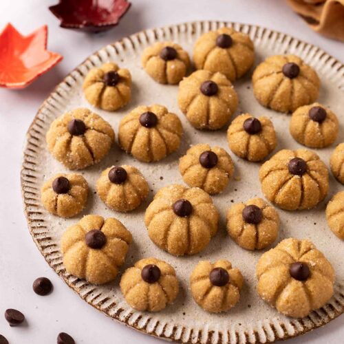 Small and cute biscoff pumpkin cake toppers on plate.