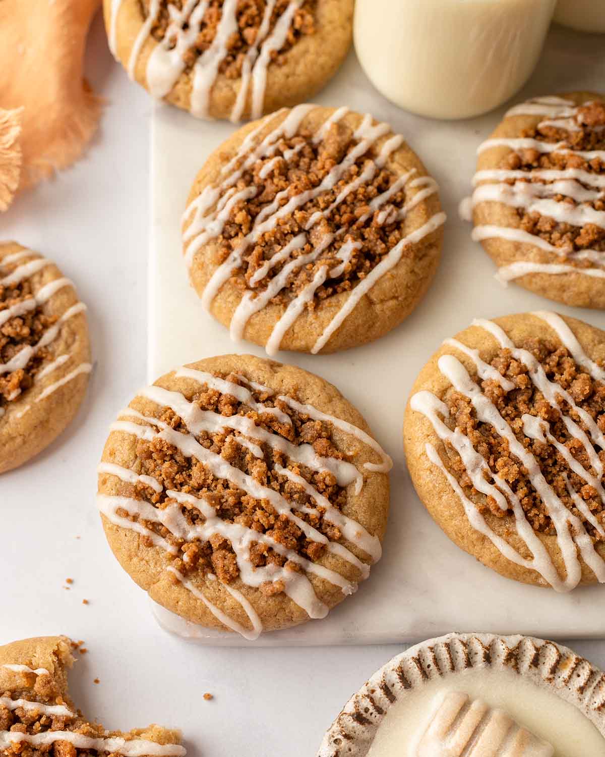 Coffee cake cookies with icing on marble board.