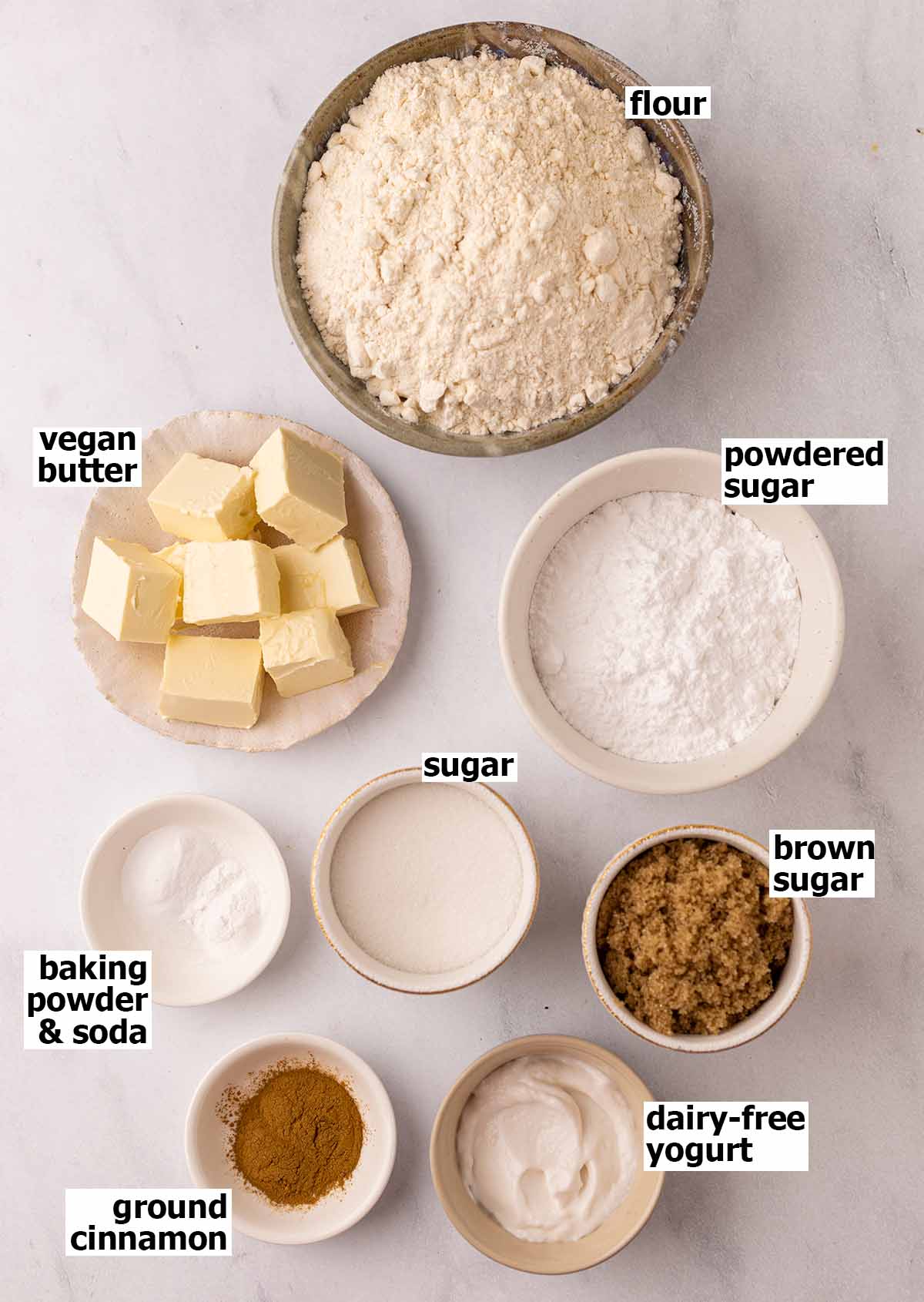 Flat-lay of ingredients for cookies, displayed in individual dishes.