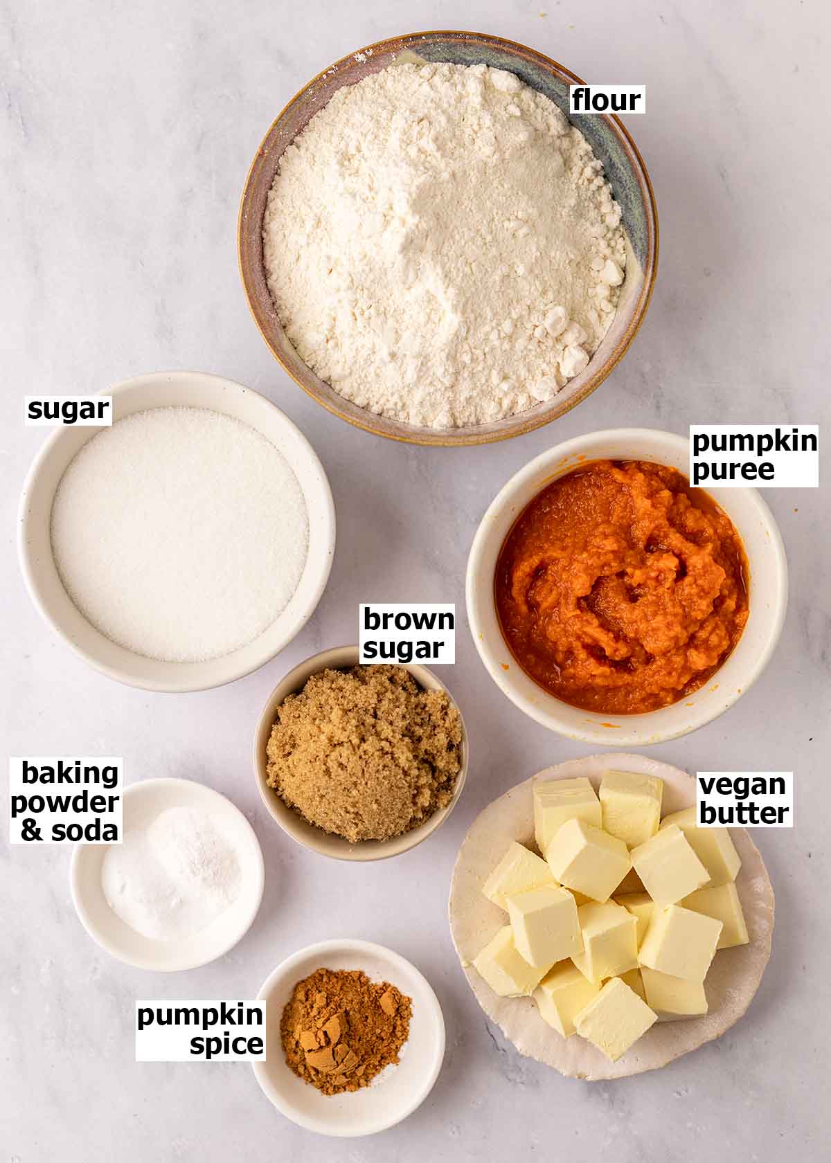 Flat-lay of ingredients placed in small dishes for the pumpkin cookies.