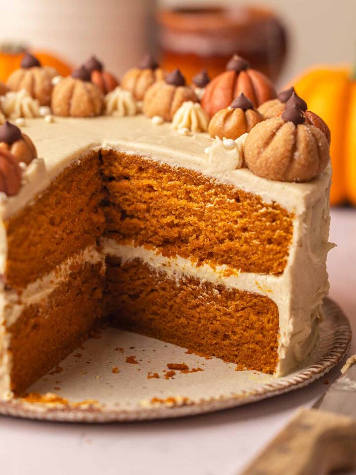 Close up of two-layer vegan pumpkin cake showing golden fluffy texture of cake.