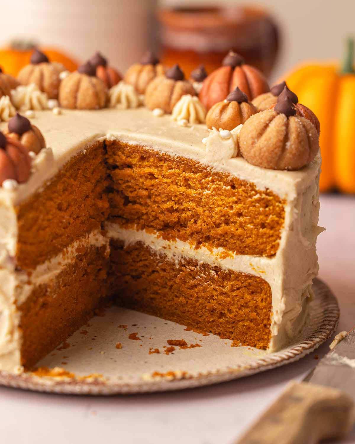 Close up of two-layer vegan pumpkin cake showing golden fluffy texture of cake.