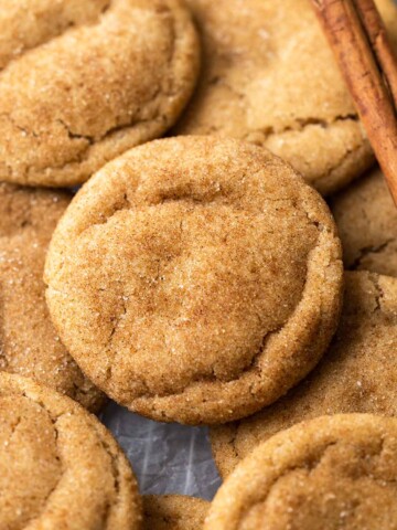 Close up of snickerdoodle cookie layered on top of more cookies.