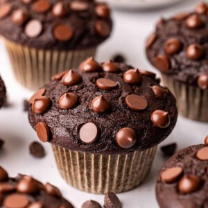 Close up of vegan chocolate muffin showing large muffin top.