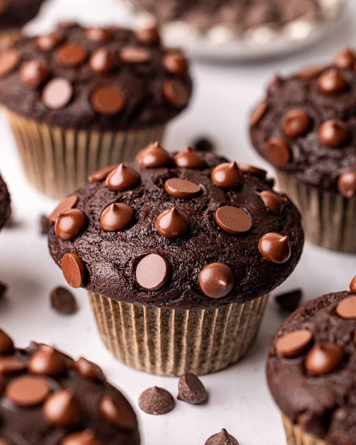 Close up of vegan chocolate muffin showing large muffin top.