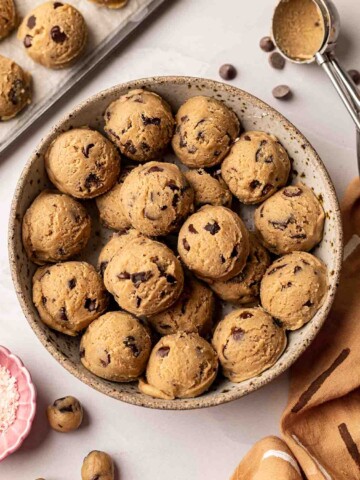 Shallow bowl filled with many scoops of cookie dough.