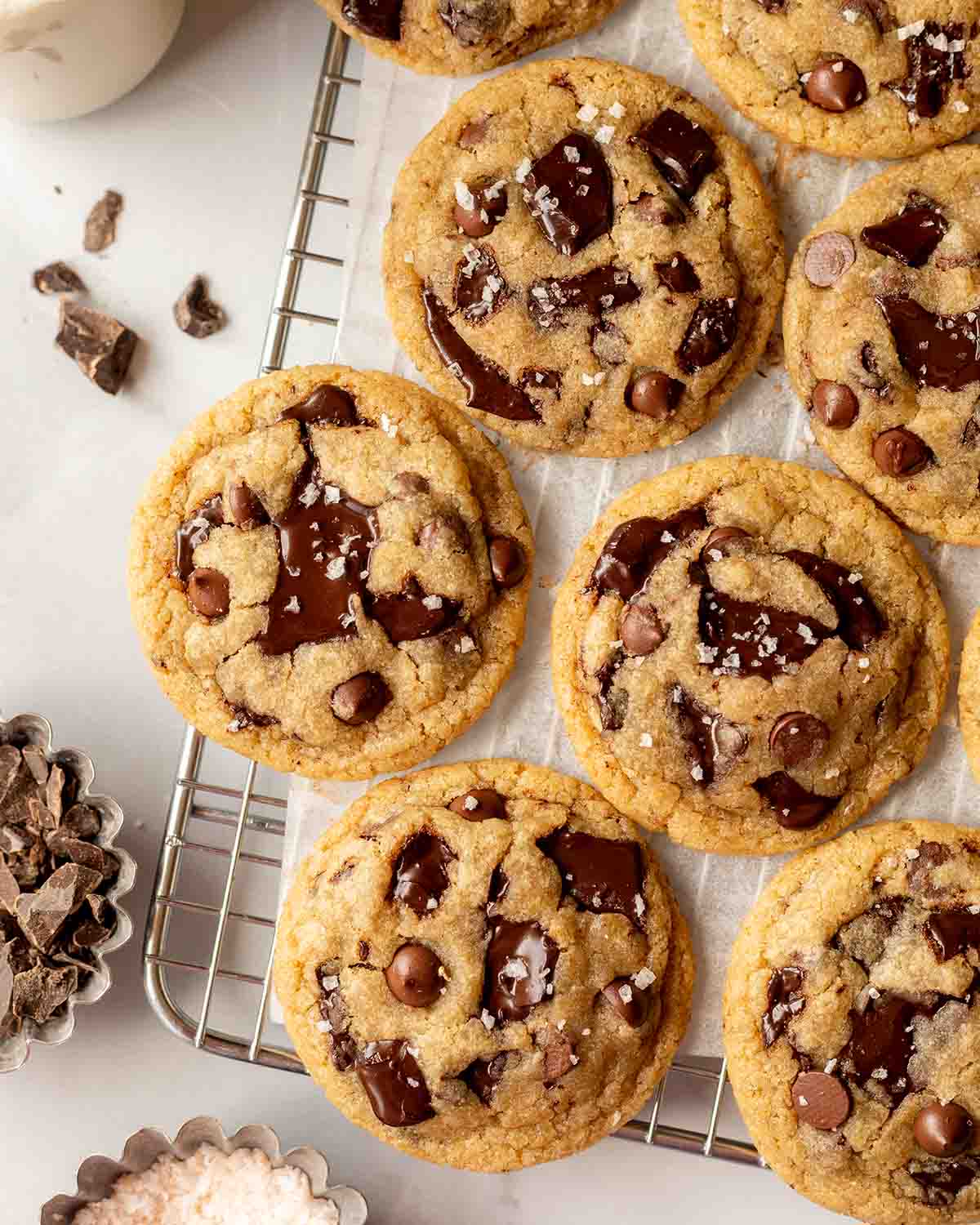 Several chocolate chip cookies on wire rack.