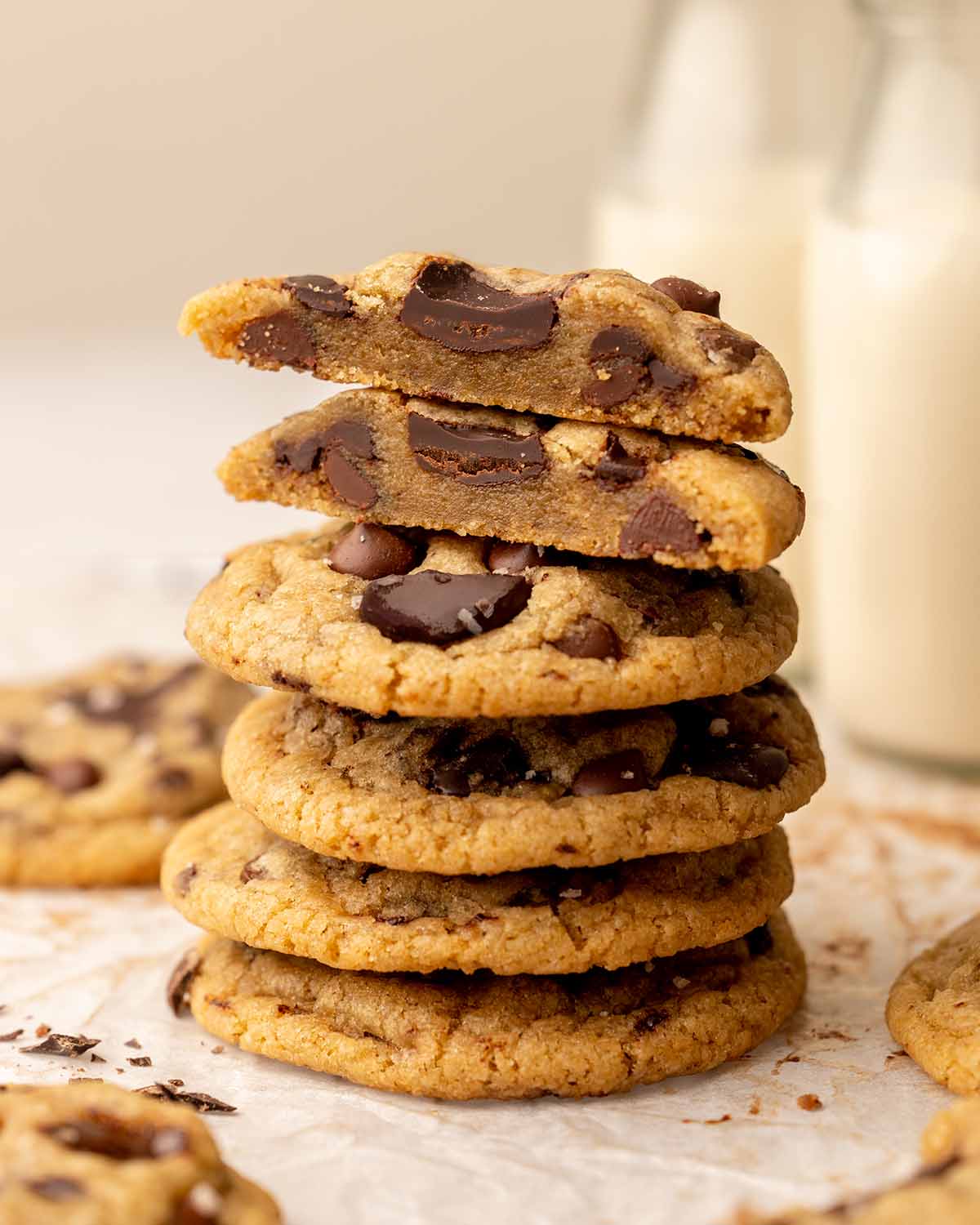 Stack of cookies with one cookie cut in half showing dense and chewy texture.