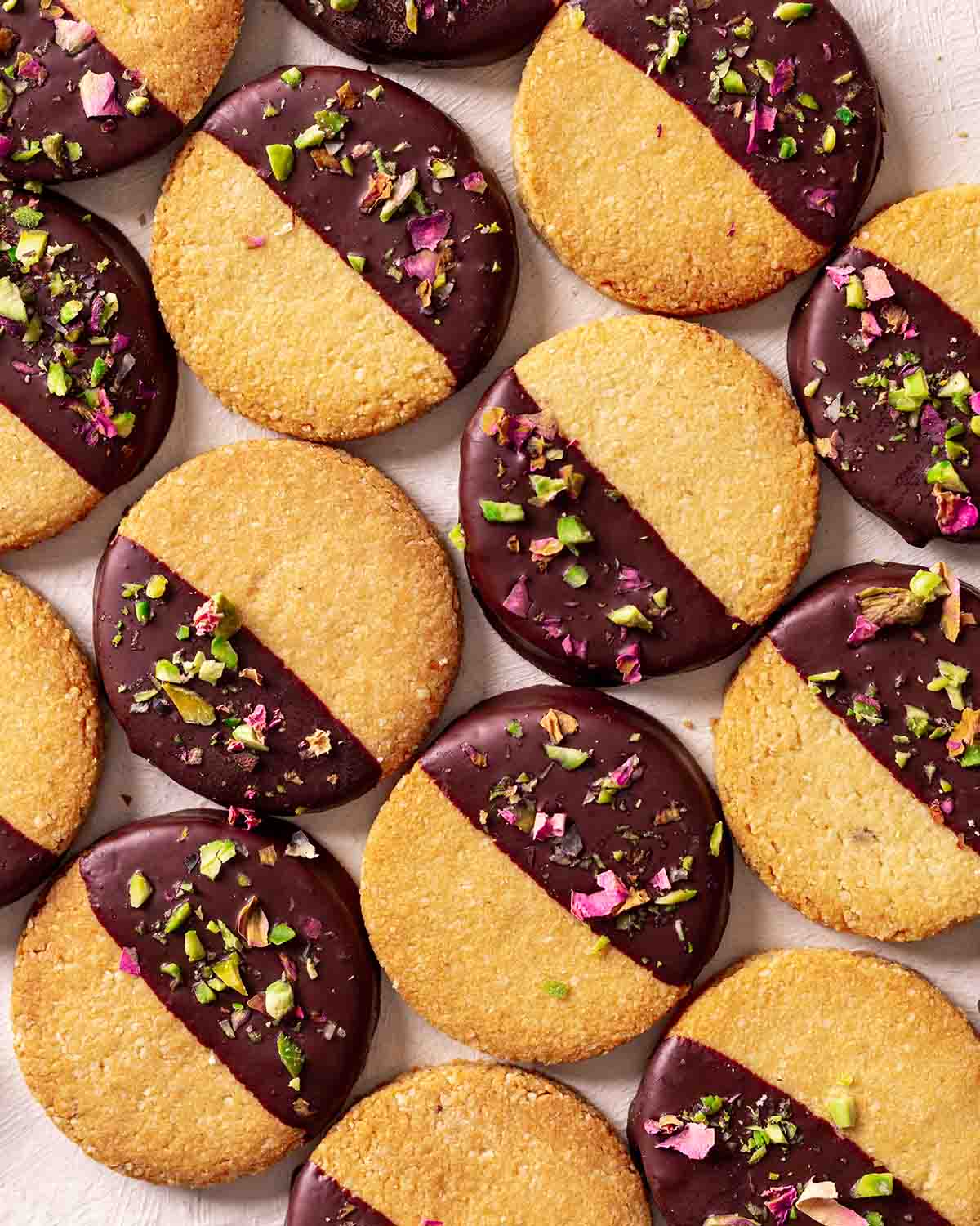 Flatlay of almond flour cookies half dipped in chocolate.