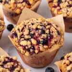 Close up of jumbo blueberry muffins in brown tulip liners.