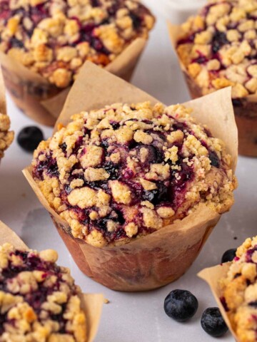 Close up of jumbo blueberry muffins in brown tulip liners.