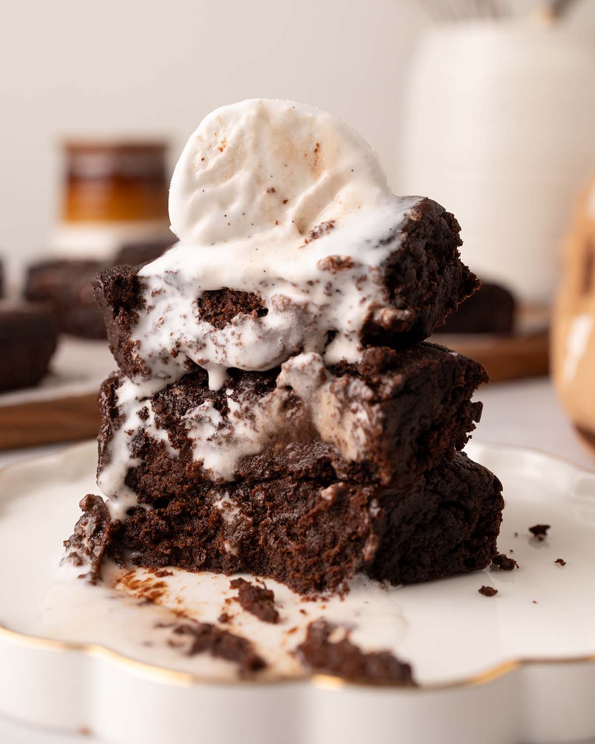 Stack of sweet potato brownies with melting ice cream.