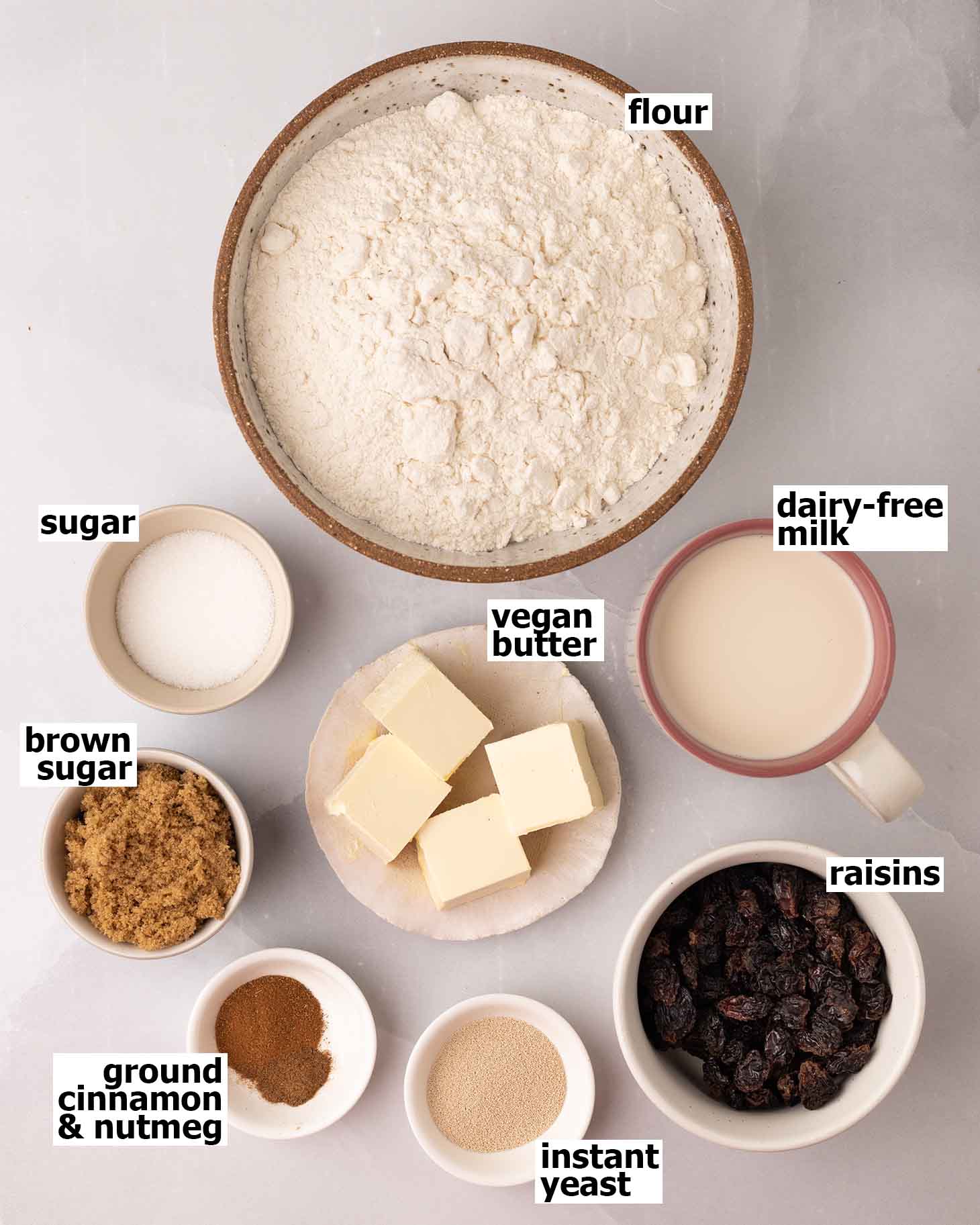 Flat-lay of ingredients for vegan hot cross cinnamon rolls.