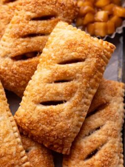 Close up of one apple pie focusing on the golden brown color and coarse sugar texture.