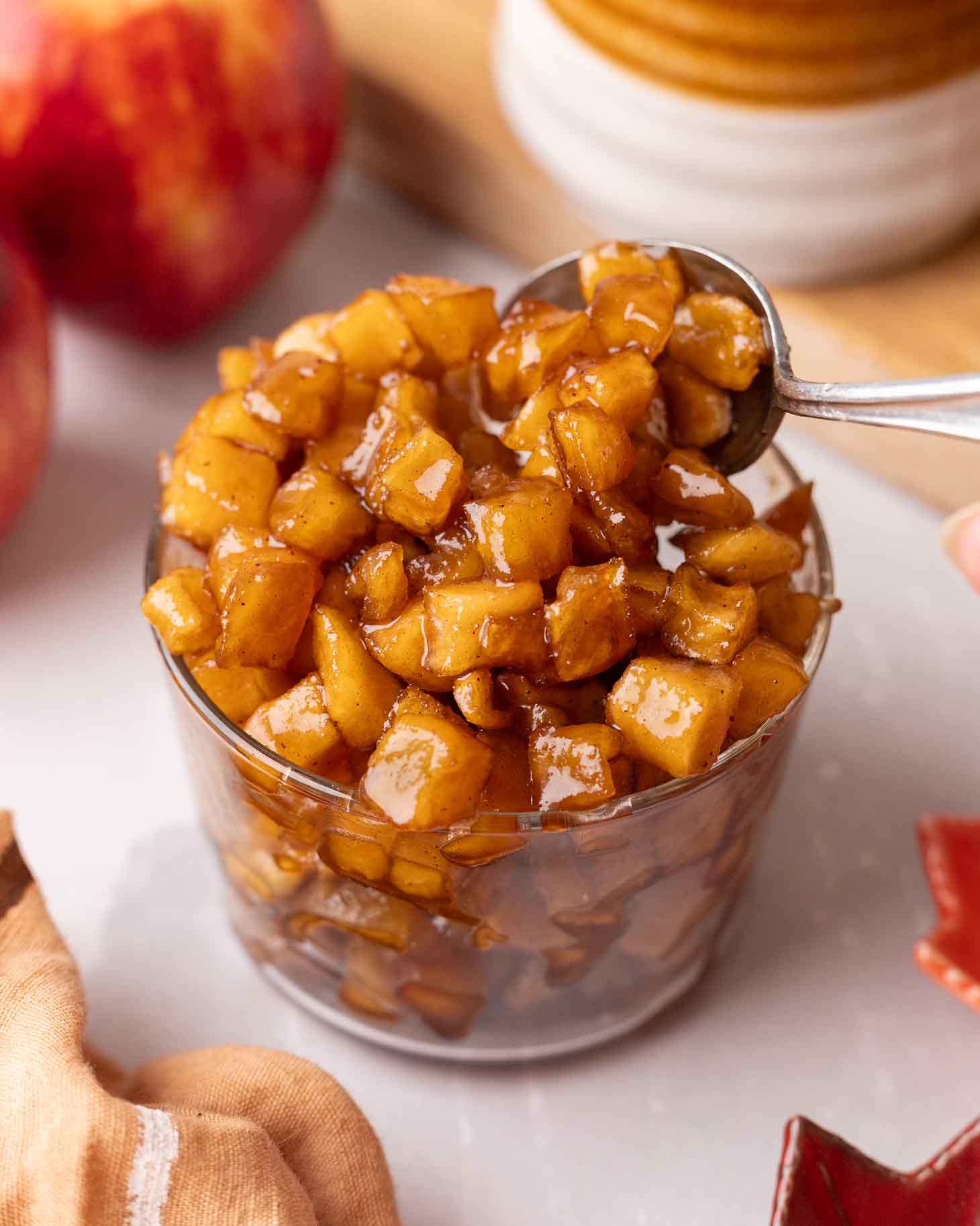 Small glass jar packed with caramelized apples.