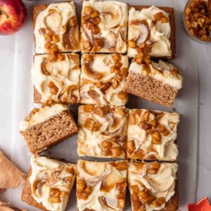 Flat-lay of applesauce cake cut into squares showing topping and some slices on their side.