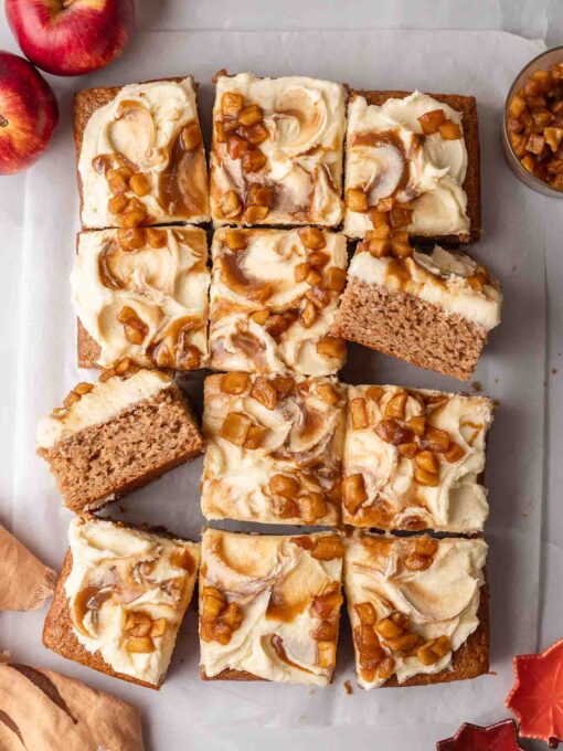 Flat-lay of applesauce cake cut into squares showing topping and some slices on their side.
