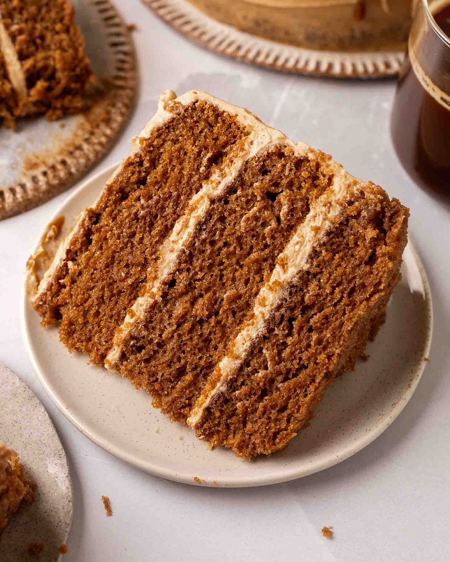 Close up of a three-layered espresso cake on a small serving plate.