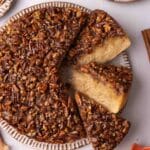 Close up of pecan upside down cake with a few slices cut out on their side to reveal their texture.