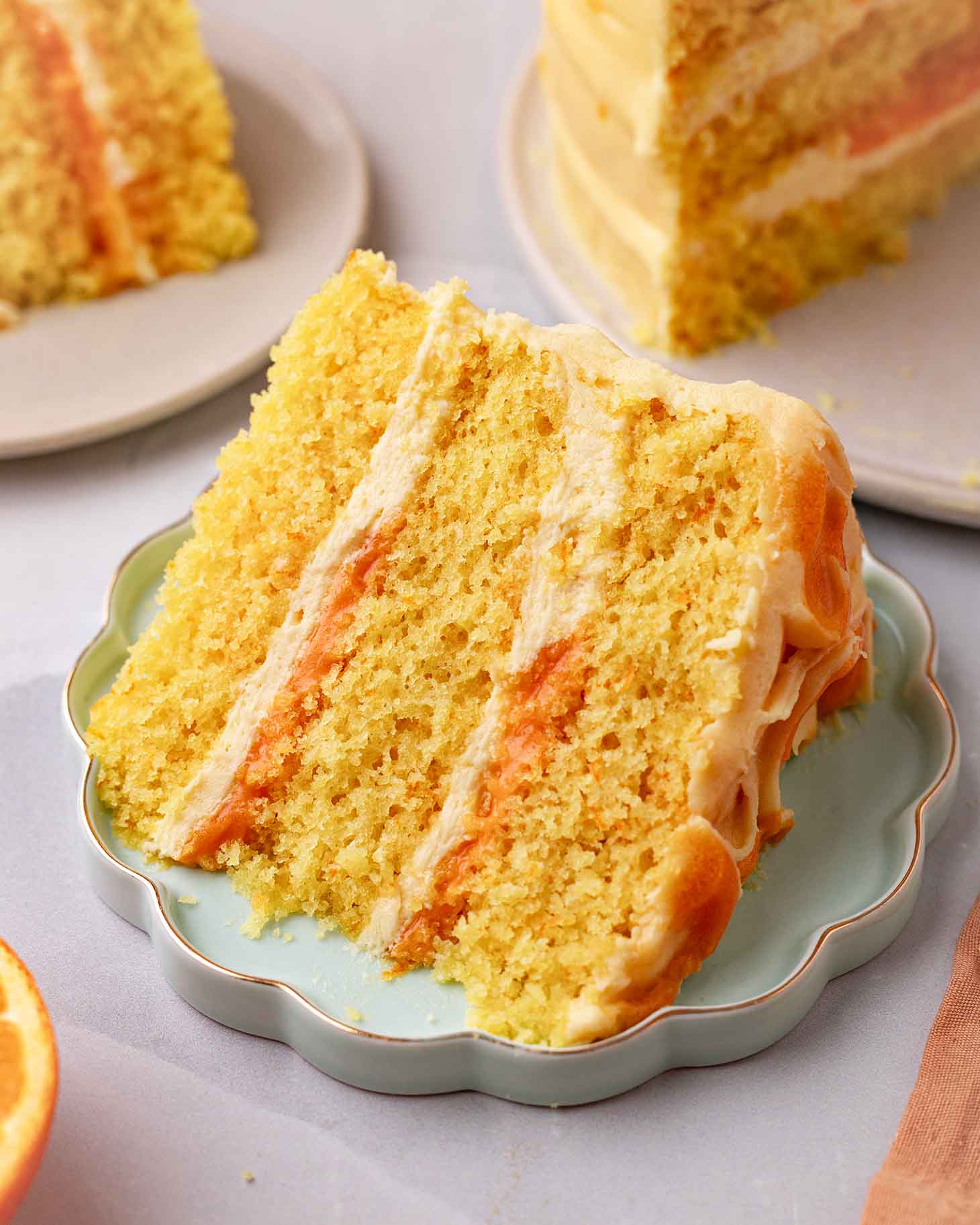 Close up of one slice of orange cake on plate.