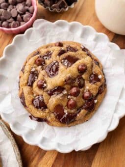 Large vegan chocolate chip cookie on parchment paper.