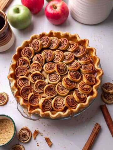 Apple pie with cinnamon pastry swirls on top.