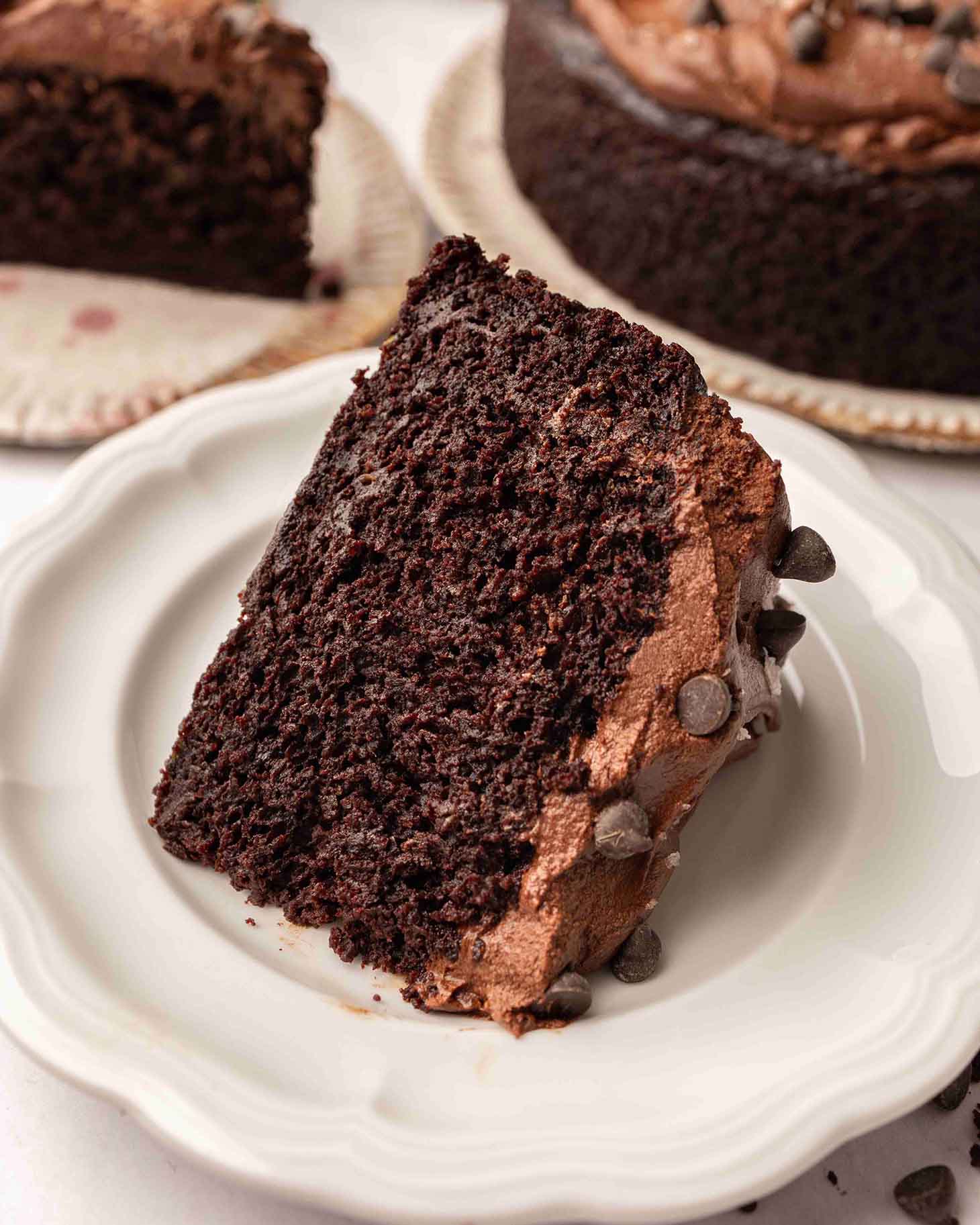 Close up of one slice of chocolate zucchini cake on its side.