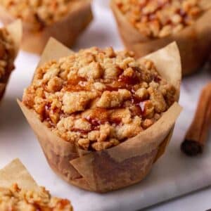 Close up of jumbo apple muffins in brown tulip liners.