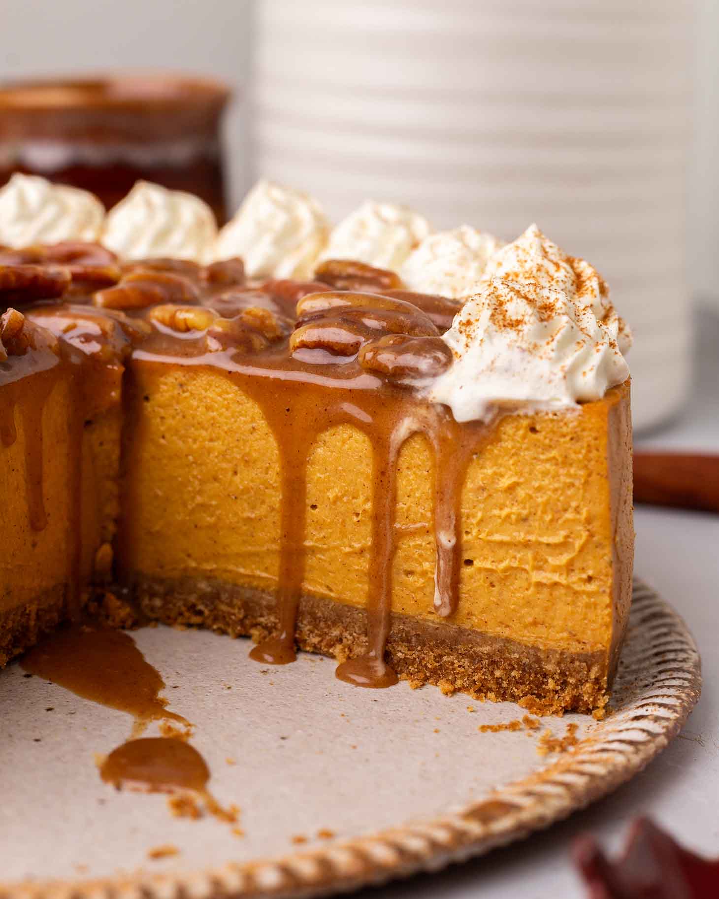 Close up of cheesecake interior focusing on smooth filling and gooey caramel topping.