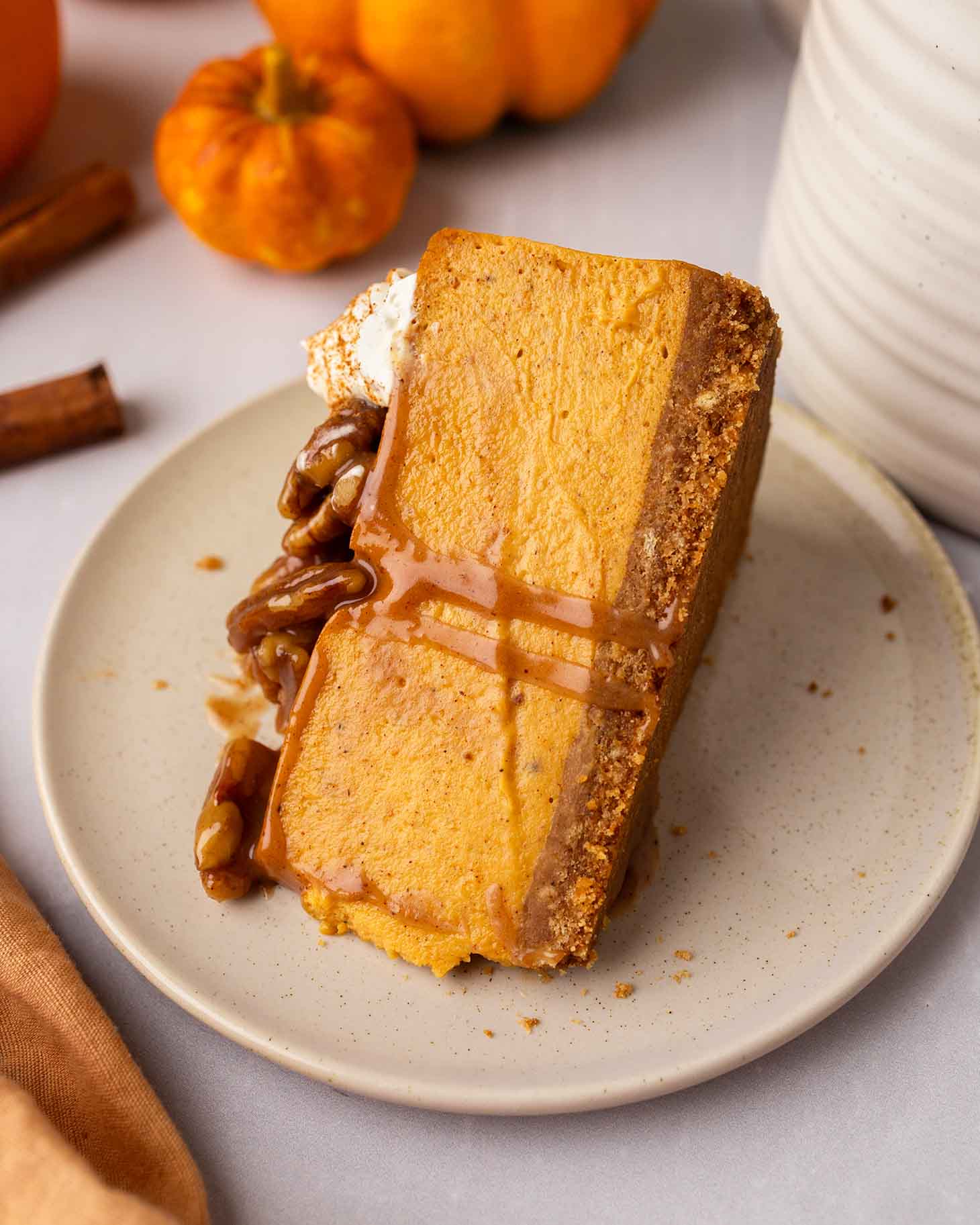 Close up of a slice of vegan pumpkin cheesecake on plate.