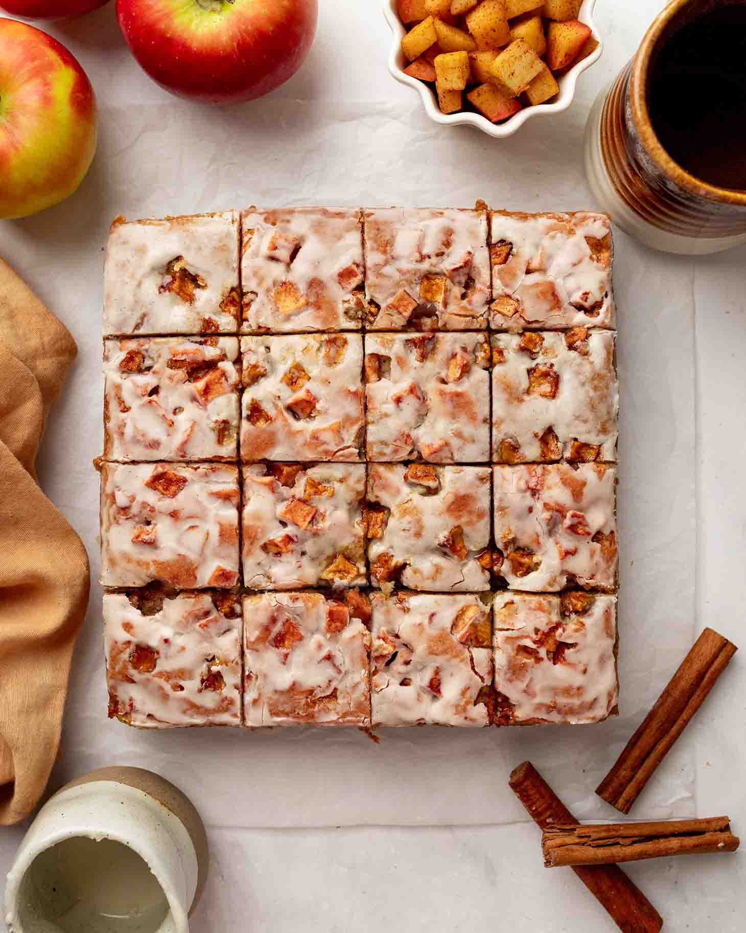 Flat-lay of whole apple fritter cake cut into slices.